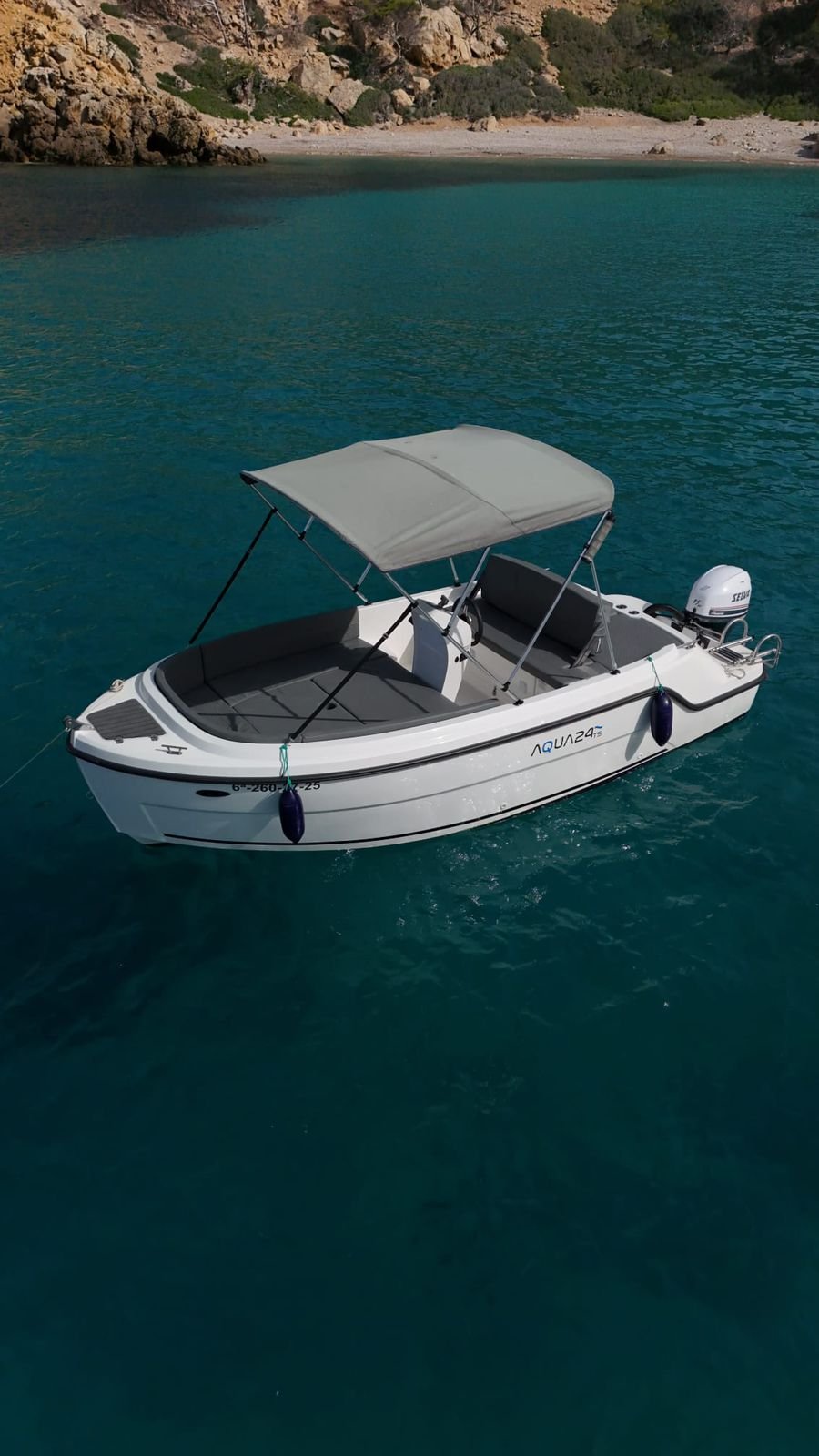Aqua 24 boat on shimmering turquoise water on the south-west coast of Mallorca